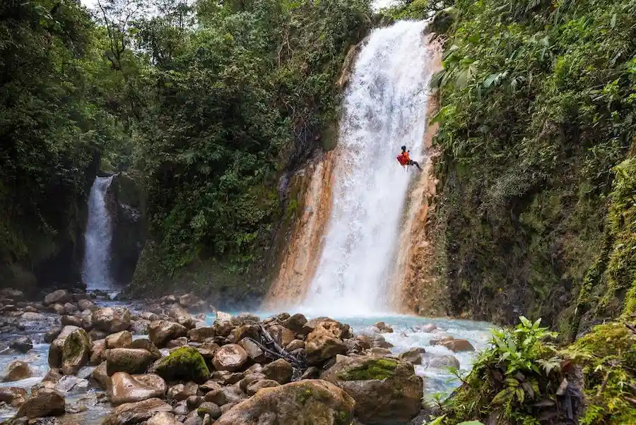 Canyoning rappel down a waterfall in Bajos del Toro, Costa Rica, with ICAN-certified guides
